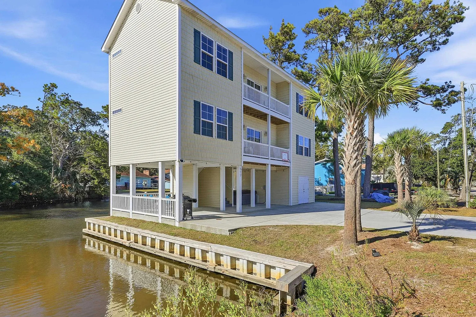 Banana Villa exterior — waterfront vacation rental in North Myrtle Beach SC with palm trees